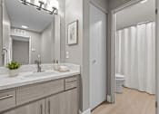 Thumbnail 48 of 87 - Modern bathroom with granite vanity and private water closet at Village Club of Farmington Hills Apartments, Farmington Hills, MI 48331