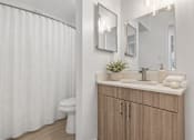 Thumbnail 9 of 33 - A white bathroom with a toilet, sink, and shower curtain.
