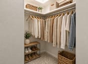 Thumbnail 28 of 35 - A white closet with clothes and shoes.
