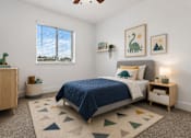 Thumbnail 13 of 33 - A bedroom with a blue bedspread and a rug with triangles on it.