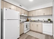 Thumbnail 1 of 50 - A kitchen with white appliances and wooden cabinets.