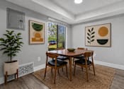 Thumbnail 10 of 50 - A dining room with a table and chairs.