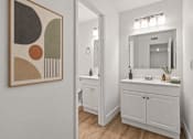 Thumbnail 19 of 29 - A bathroom with a white cabinet and a mirror above it.