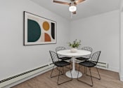 Thumbnail 16 of 29 - A dining room with a white table and chairs.