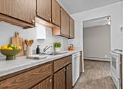 Thumbnail 1 of 29 - A kitchen with wooden cabinets and white appliances.