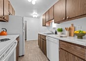 Thumbnail 2 of 29 - A kitchen with white appliances and wooden cabinets.