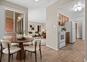 Thumbnail 5 of 29 - A modern kitchen with a dining table set for four.