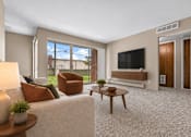 Thumbnail 3 of 29 - A living room with a white couch, a brown armchair, a wooden coffee table, and a flat-screen TV mounted on the wall.