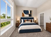 Thumbnail 3 of 64 - A bedroom with a large bed and a painting on the wall.