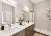 Thumbnail 7 of 64 - A bathroom with a white sink and a white counter top.