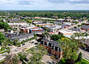 Thumbnail 87 of 87 - A small town with a lot of greenery and buildings. at Village Club of Farmington Hills Apartments, Farmington Hills, MI