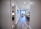Thumbnail 10 of 31 - a view of a living room and dining room from the hallway of a house