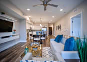 Thumbnail 12 of 31 - a living room with a couch and a ceiling fan