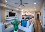 Thumbnail 8 of 31 - a living room with a couch and a ceiling fan