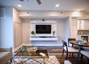Thumbnail 13 of 31 - a living room with a tv and a table