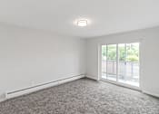 Thumbnail 22 of 44 - A room with a carpeted floor and a window overlooking a parking lot. at The Park on 13 Apartments - Royal Oak, MI Apartments, Apartments, Royal Oak, MI