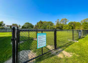 Thumbnail 19 of 21 - a dog park with a black chain link fence and a sign that says dog park closed  at Park On Canal Apartments, Clinton Twp, MI
