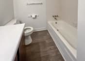 Thumbnail 11 of 35 - a bathroom with a toilet sink and bathtub