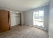 Thumbnail 3 of 35 - an empty bedroom with a large window and a closet