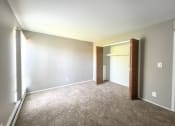 Thumbnail 12 of 35 - a bedroom with a carpeted floor and an open door