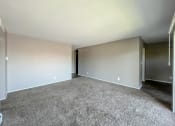Thumbnail 7 of 35 - a bedroom with a carpeted floor and grey walls
