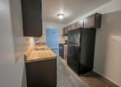 Thumbnail 13 of 35 - a kitchen with a blue refrigerator freezer next to a stove top oven