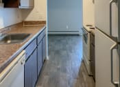 Thumbnail 5 of 35 - a kitchen with white appliances and blue cabinets
