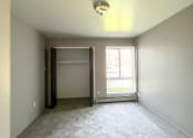 Thumbnail 10 of 35 - an empty bedroom with a window and a closet