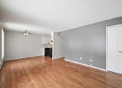 Thumbnail 16 of 45 - A room with a wooden floor and a ceiling fan.