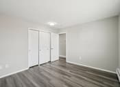 Thumbnail 31 of 45 - A room with a white door and a grey floor.