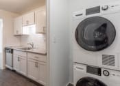 Thumbnail 10 of 25 - a white kitchen with a washer and dryer