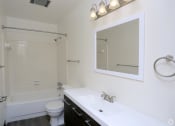 Thumbnail 11 of 25 - a bathroom with a sink toilet and bathtub