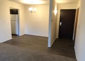 Thumbnail 12 of 25 - an empty room with a refrigerator and a door