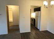 Thumbnail 13 of 25 - a kitchen with a white refrigerator freezer next to a doorway