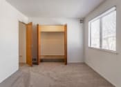 Thumbnail 14 of 25 - a bedroom with an open door and a window