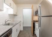 Thumbnail 17 of 25 - a kitchen with white cabinets and a stainless steel refrigerator