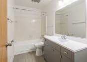 Thumbnail 20 of 25 - a bathroom with a sink toilet and bathtub