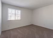 Thumbnail 21 of 25 - an empty room with a window and carpet
