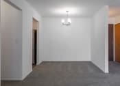 Thumbnail 22 of 25 - an empty room with a chandelier and a door