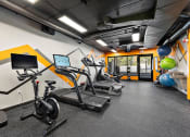 Thumbnail 48 of 73 - a gym with cardio equipment and weights in a building at Troy Place Apartments - Troy, MI, Troy, Michigan