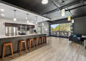 Thumbnail 59 of 73 - a kitchen with a bar and stools at Troy Place Apartments - Troy, MI, Michigan