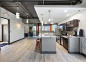 Thumbnail 61 of 73 - an open kitchen and living room with a large island at Troy Place Apartments - Troy, MI, Troy, Michigan
