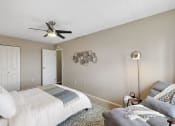 Thumbnail 40 of 73 - a bedroom with a bed and a ceiling fan at Troy Place Apartments - Troy, MI, Troy