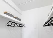 Thumbnail 11 of 73 - a white closet with shelves and hooks on the wall at Troy Place Apartments - Troy, MI, Troy, Michigan