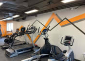 Thumbnail 50 of 73 - a workout room with treadmills and other exercise equipment in a gym at Troy Place Apartments - Troy, MI, Troy, Michigan