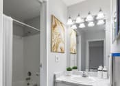 Thumbnail 44 of 73 - a bathroom with a sink and a toilet and a mirror at Troy Place Apartments - Troy, MI, Michigan