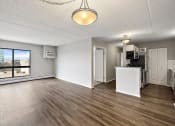 Thumbnail 30 of 73 - the living room and kitchen of an empty apartment at Troy Place Apartments - Troy, MI, Troy, Michigan