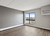Thumbnail 31 of 73 - living room with a large window and wood floors at Troy Place Apartments - Troy, MI, Troy, Michigan