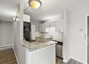 Thumbnail 14 of 73 - a kitchen with a granite counter top at Troy Place Apartments - Troy, MI, Michigan