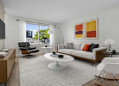 Thumbnail 4 of 14 - A modern living room with a white sofa, a black chair, a white coffee table, and a white rocking chair.